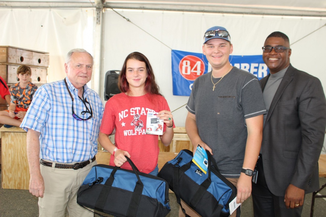 David Smith, deputy commissioner for the N.C. Department of Agriculture, left, and Bruce Mack, Ed.D., right, presented the winning team with their awards and prizes. #students #apprenticeship